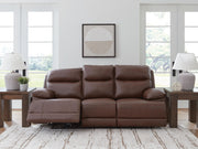 Signature Design by Ashley Vonryan power reclining sofa with adjustable headrest in tobacco leather, showing plush cushions and sleek design.