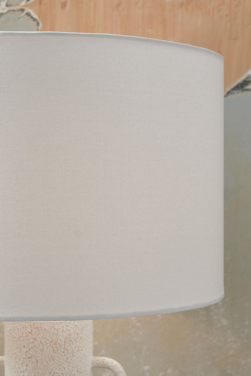 Distressed white metal table lamp with a sleek, modern design by Signature Design by Ashley® for stylish home lighting.