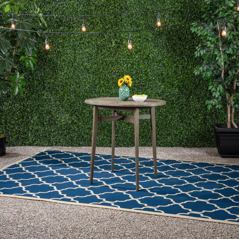 Noble House outdoor acacia wood bar table with slat top, sturdy design suitable for patio or garden entertaining.