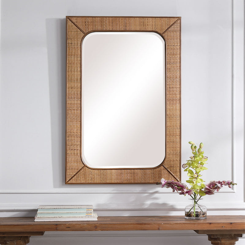 Light brown rattan wall mirror from Uttermost's Tahiti collection, featuring a round frame and natural woven design.