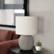 Contemporary gray and cream concrete table lamp by 8th Street with a sleek, minimalist design and cylindrical shape.