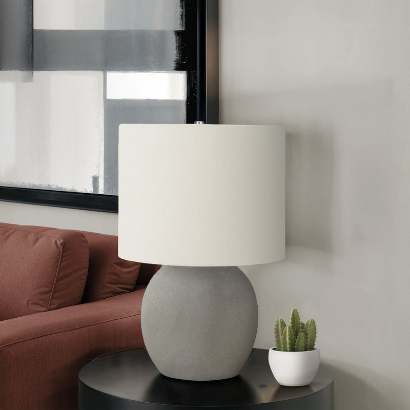 Contemporary gray and cream concrete table lamp by 8th Street with a sleek, minimalist design and cylindrical shape.