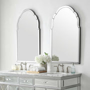 Uttermost Brayden frameless arched wall mirror with pearl silver finish, showcasing a sleek, modern design with clean lines and reflective surface.