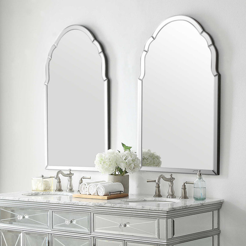 Uttermost Brayden frameless arched wall mirror with pearl silver finish, showcasing a sleek, modern design with clean lines and reflective surface.