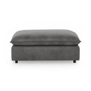 Classic Home Caplan upholstered ottoman in neutral fabric, showcasing a stylish and comfortable footstool with a modern design.