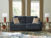 Signature Design by Ashley Danum 2 Seat Reclining Sofa in dark fabric, showing plush cushions and reclining features.