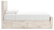 Signature Design by Ashley Lawroy panel bed with built-in storage drawers in a modern bedroom setting.