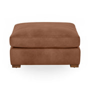 Classic Home Audrey upholstered ottoman with a plush fabric top and wooden legs, ideal for living room or bedroom decor.