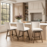 Classic Home Ava swivel counter stool in vanilla oat fabric with wooden legs, 24-27 inch height for kitchen or bar area.