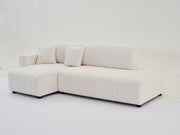 Urban Retreats Jessica lamb wool sectional sofa with chaise, showcasing a versatile stationary sectional in a modern living room setting.