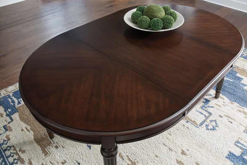 Lavinton - Oval Dining Room Extension Table - Brown - R&R Furniture Gallery (Fountain Valley, CA)