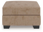 Benchcraft® Olten accent ottoman with plush fabric and wooden legs, perfect for living room decor and extra seating.