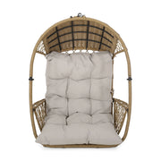 Light brown wicker hanging chair with beige cushions and 8-foot chain, ideal for outdoor or indoor relaxation by Noble House.