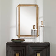 Uttermost Amherst wall mirror with elegant frame, reflecting light and adding style to a modern decor space.