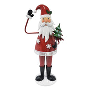 Cheerful Christmas Santa Claus figure from Noble House holding a tree and waving, festive holiday decoration in red.