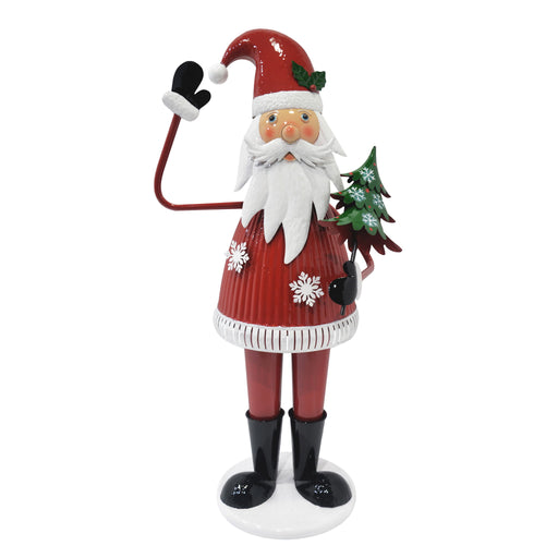 Cheerful Christmas Santa Claus figure from Noble House holding a tree and waving, festive holiday decoration in red.