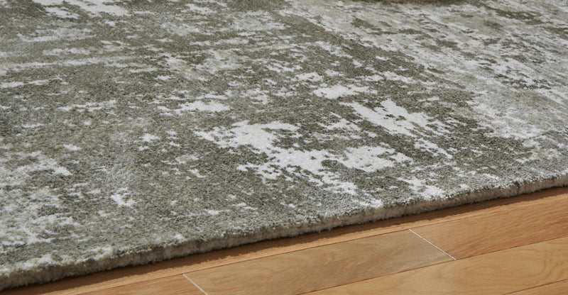 Signature Design by Ashley Valmontic area rug featuring intricate patterns and soft colors for stylish home decor.