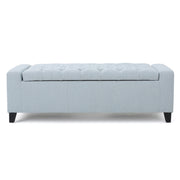 Noble House Guernsey storage ottoman with tufted top, beige fabric, and sturdy wooden legs, serving as both seat and storage.