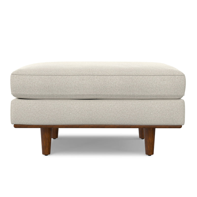 Simpli-Home Morrison handcrafted upholstered ottoman with cushioned top and wooden legs on a neutral background.