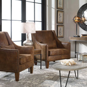 Dark brown leather armchair from Uttermost featuring a plush, upholstered leather seat and sleek armrest design.