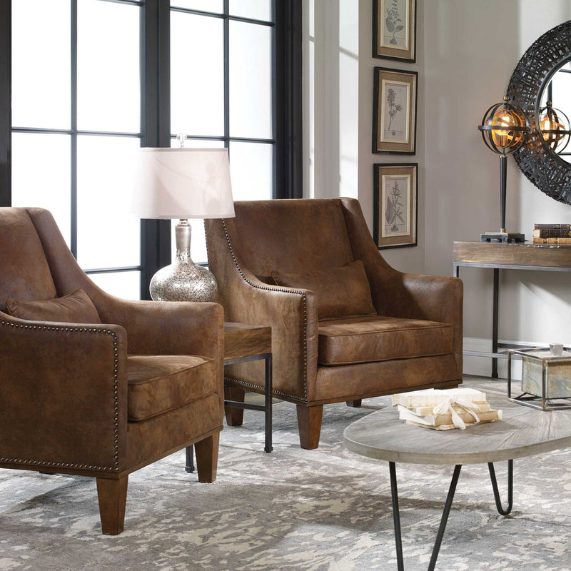 Dark brown leather armchair from Uttermost featuring a plush, upholstered leather seat and sleek armrest design.