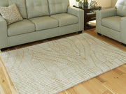 Signature Design by Ashley Jaseena area rug with intricate geometric patterns and soft neutral colors, perfect for living rooms.