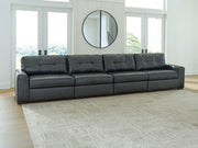 Signature Design by Ashley® Brindley Pier sectional sofa in neutral fabric with plush cushions and wide armrests.
