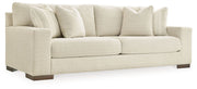 Signature Design by Ashley Maggie stationary sofa with plush cushions and neutral fabric, ideal for living room seating.