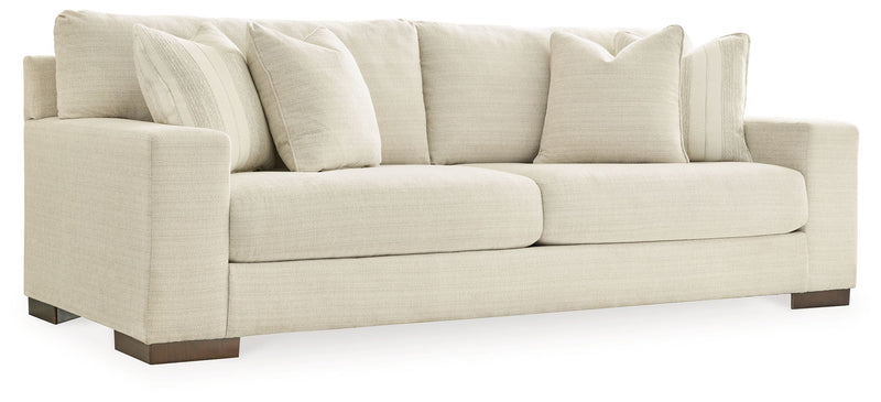 Signature Design by Ashley Maggie stationary sofa with plush cushions and neutral fabric, ideal for living room seating.