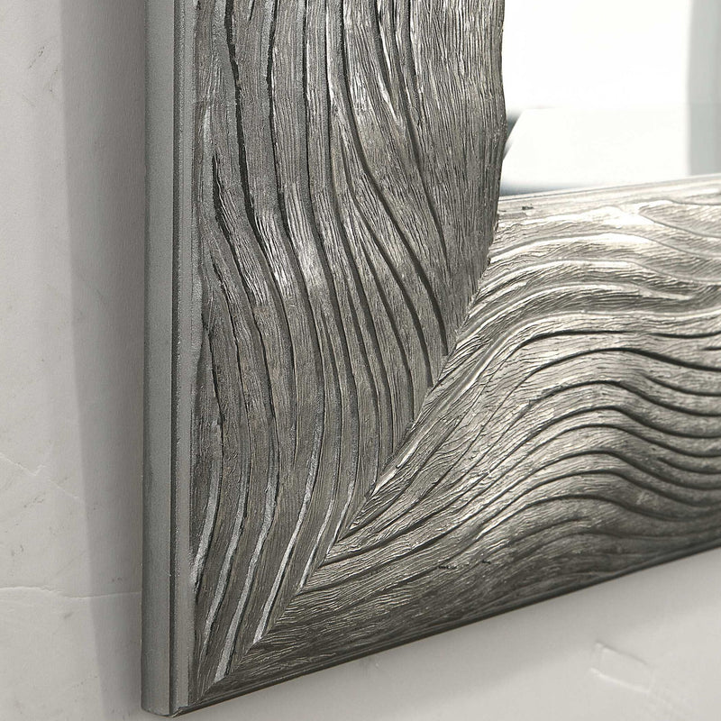 Silver metallic wall mirror by Uttermost, Maeona style, with a sleek round frame reflecting contemporary decor.