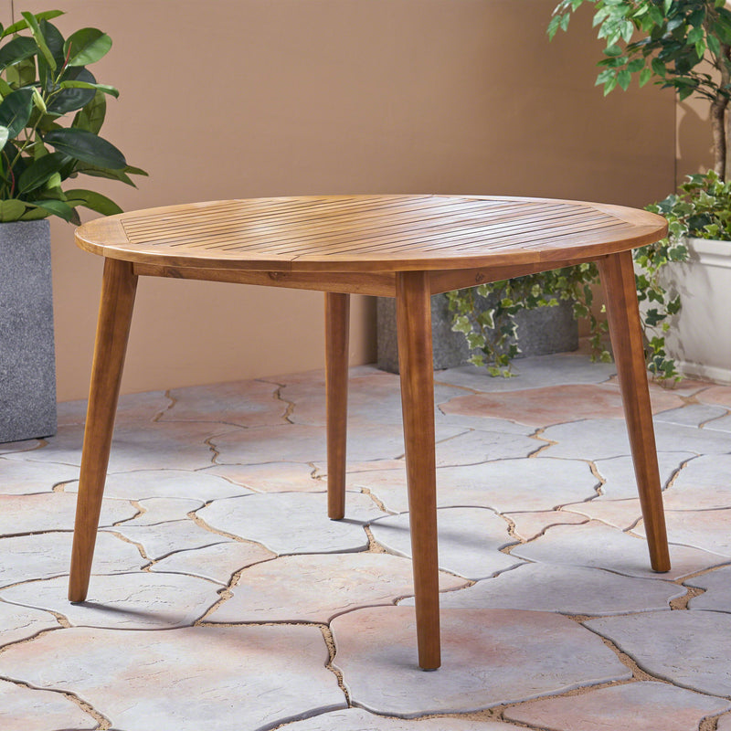 Modern Noble House Stamford outdoor dining table with sleek design and sturdy wooden construction for patio or garden use.