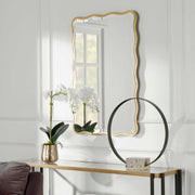 Gold scalloped accent mirror by Uttermost, featuring a decorative, wavy edge design for stylish wall decor.