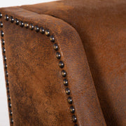 Dark brown leather armchair from Uttermost, featuring a plush, cushioned seat and stylish armrests in a contemporary design.
