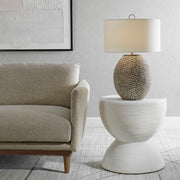 Uttermost Cyprien gray and white table lamp with a modern, sleek design and smooth ceramic base on a neutral surface.