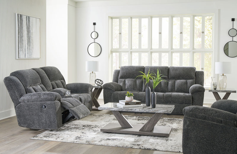Signature Design by Ashley Frohn reclining living room sofa with plush fabric, padded armrests, and built-in recliner mechanism.