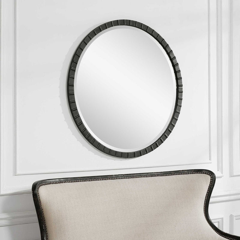 Round industrial wall mirror by Uttermost with a metal frame, featuring a sleek, modern design for stylish home decor.