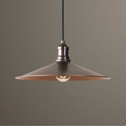 Uttermost Barnstead 1-light copper pendant lighting with light brown finish, hanging from a ceiling with a warm, inviting glow.