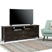 Simpli-Home Burlington TV media stand with open shelves and storage cabinets, made of wood with a natural finish.