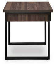 Signature Design by Ashley Wickman Falls rectangular cocktail table with a sleek wood finish and modern design.