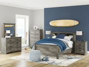 Signature Design by Ashley Frandern 6-piece bedroom set with bookcase panel headboard, dresser, and nightstands in a modern bedroom scene.