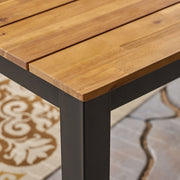 Black rectangular outdoor dining table with iron legs from Noble House, showcasing a sturdy tabletop perfect for outdoor meals.