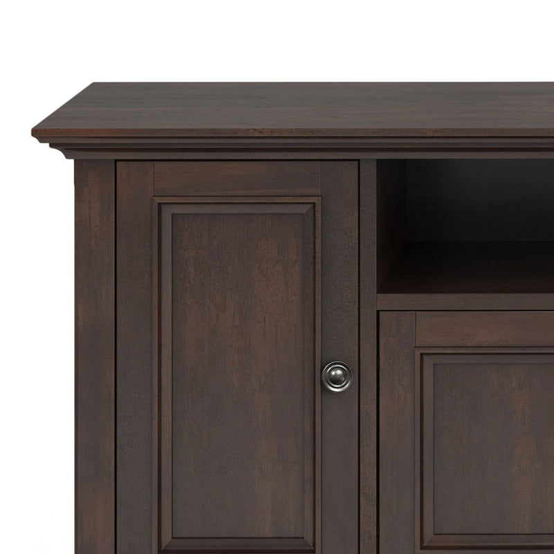 Wide TV media stand by Simpli-Home featuring wood finish, open shelving, and storage compartments for entertainment equipment.