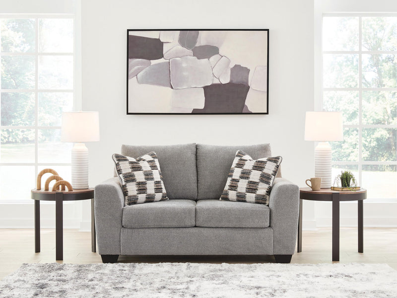 Benchcraft® stationary loveseat from Loreo with plush fabric and cushioned seats, perfect for cozy living room seating.
