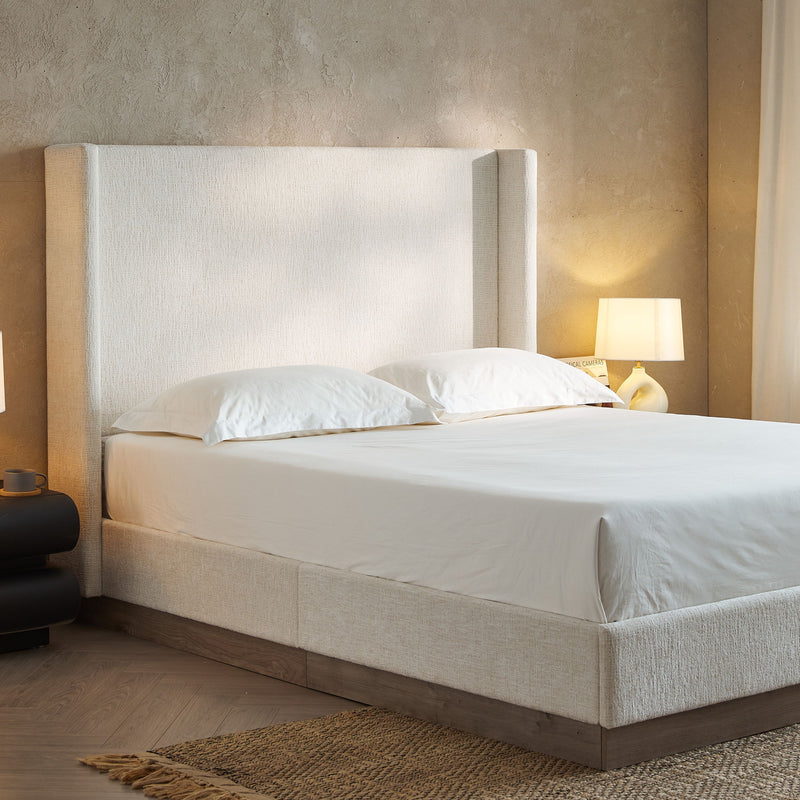 House & Home Furniture Hosford minimalist upholstered wingback bed with wood base platform, showcasing the sleek, modern design.