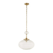 Uttermost Bellaire gold pendant light with a clear glass shade, hanging from a ceiling mount, ideal for modern lighting decor.