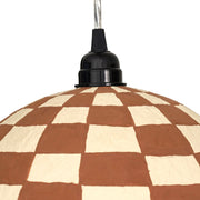TOV Furniture Taurus cotton mache pendant lamp in white and terracotta with a rounded, sculptural design hanging from the ceiling.