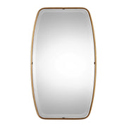 Uttermost Canillo wall mirror with a sleek, modern frame hanging on a wall, reflecting indoor decor.