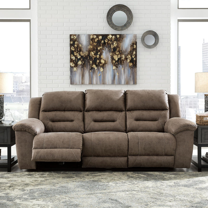 Signature Design by Ashley Stoneland power reclining sofa with plush cushions and dark leather upholstery.