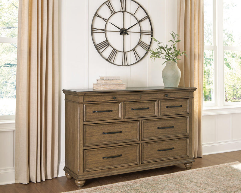 Signature Design by Ashley Karallin dresser featuring multiple drawers and a sleek wooden finish for bedroom storage.