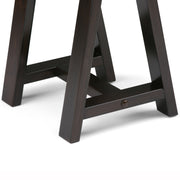 Handcrafted Simpli-Home console sofa table with sawhorse-style legs, made of wood for a rustic, stylish living room accent.
